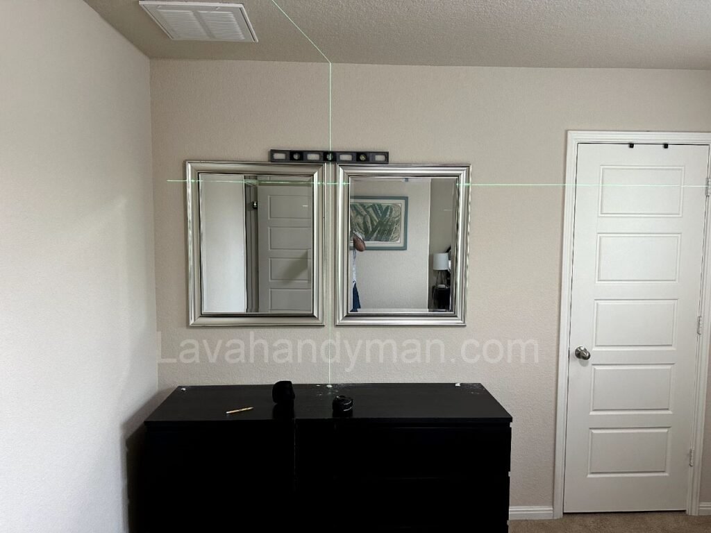 Installing a Mirror on the Wall with a Laser Level